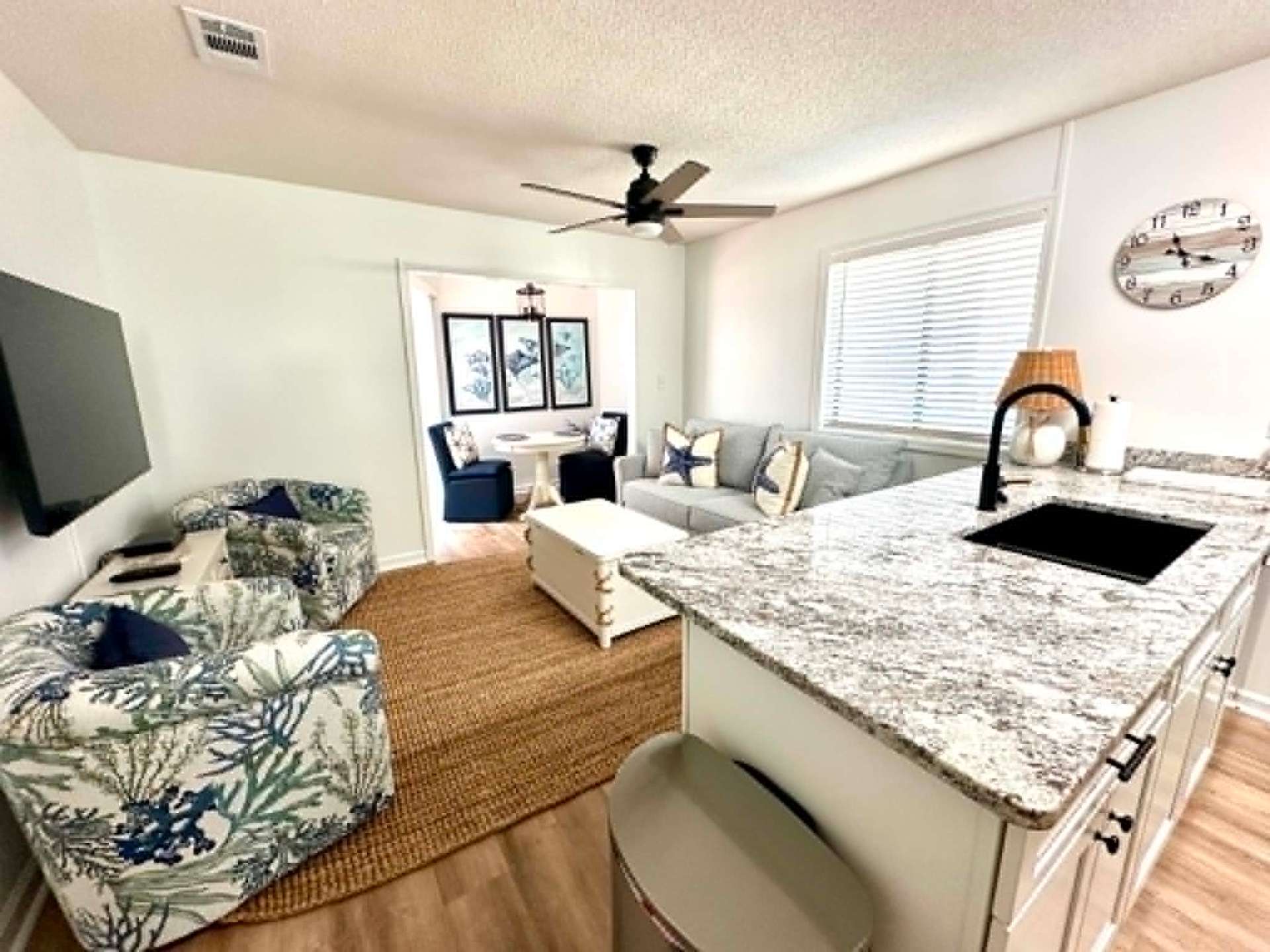 Bright coastal living room and kitchen, freshly cleaned