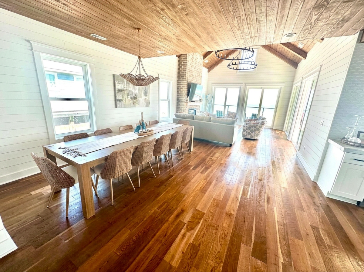 Open coastal dining and living area with hardwood floors, freshly cleaned