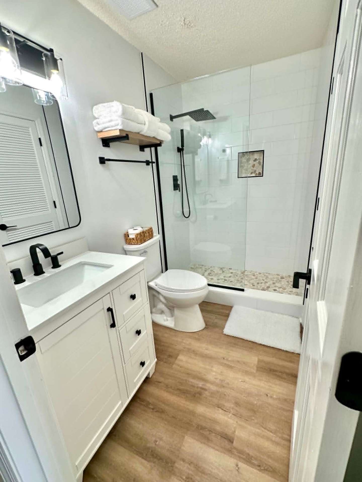 Modern guest bath with walk-in shower and matte black fixtures, freshly cleaned