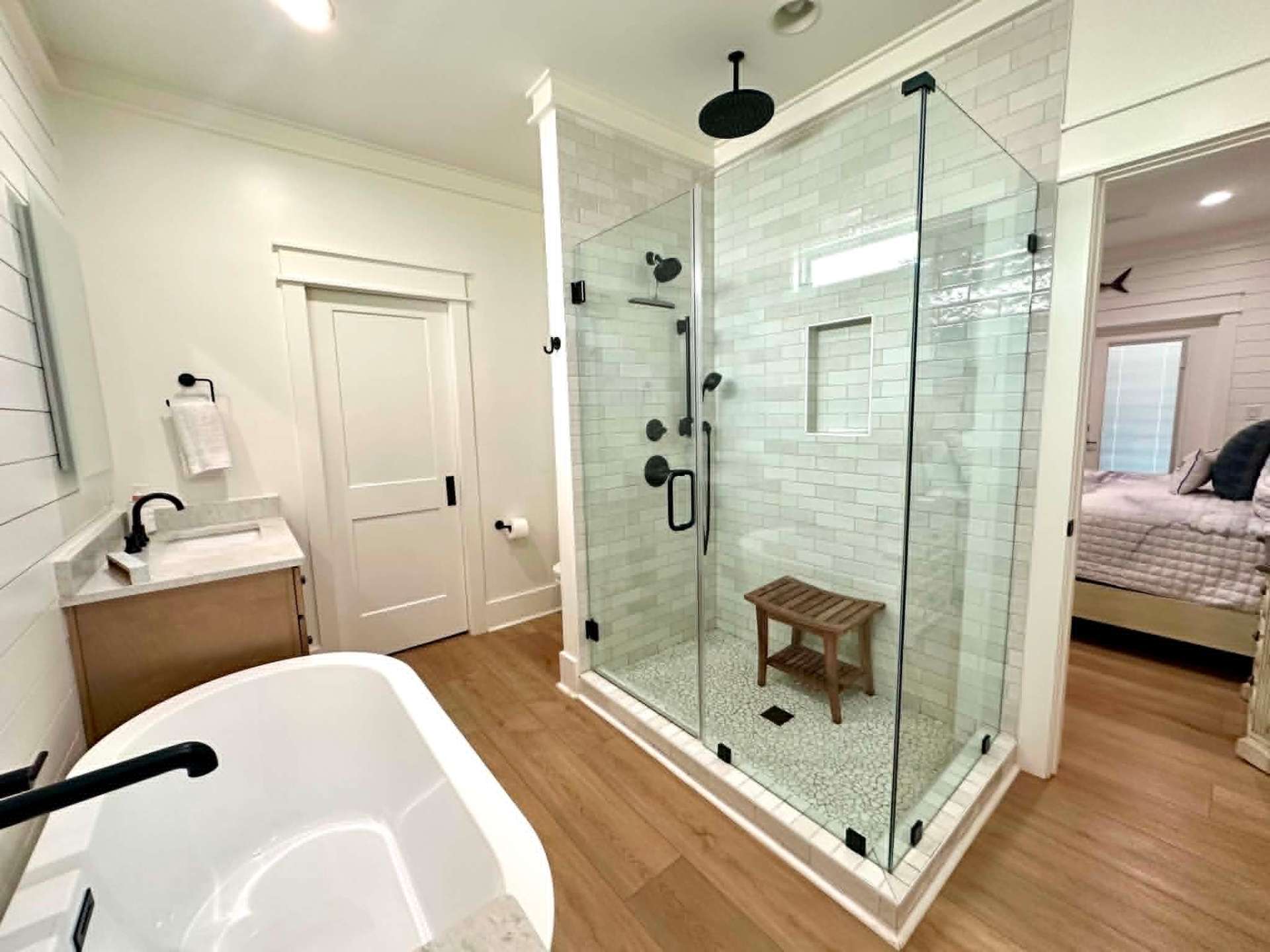 Spacious master bath with glass shower and freestanding tub, freshly cleaned