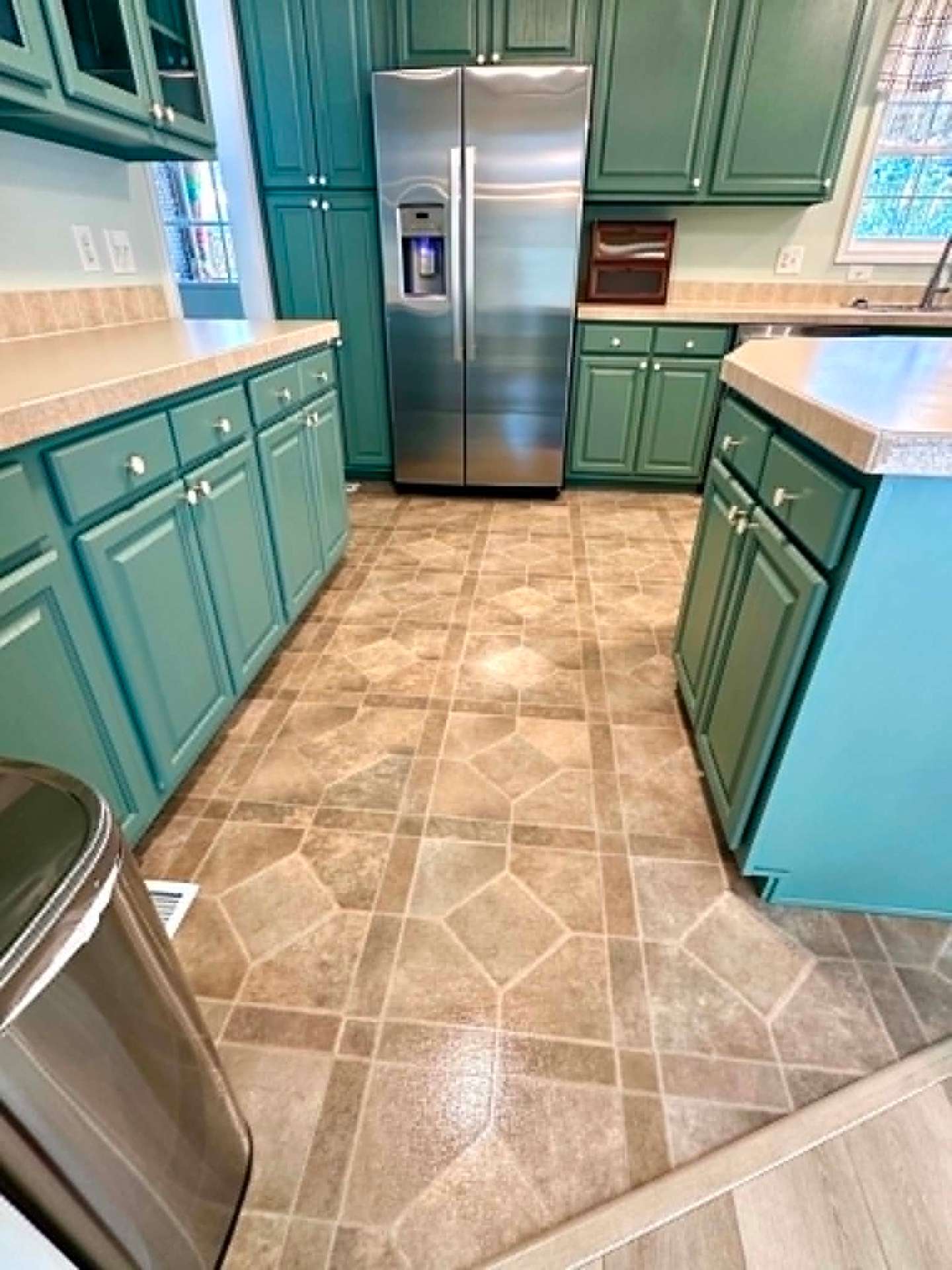 Teal cabinet kitchen with polished tile floors