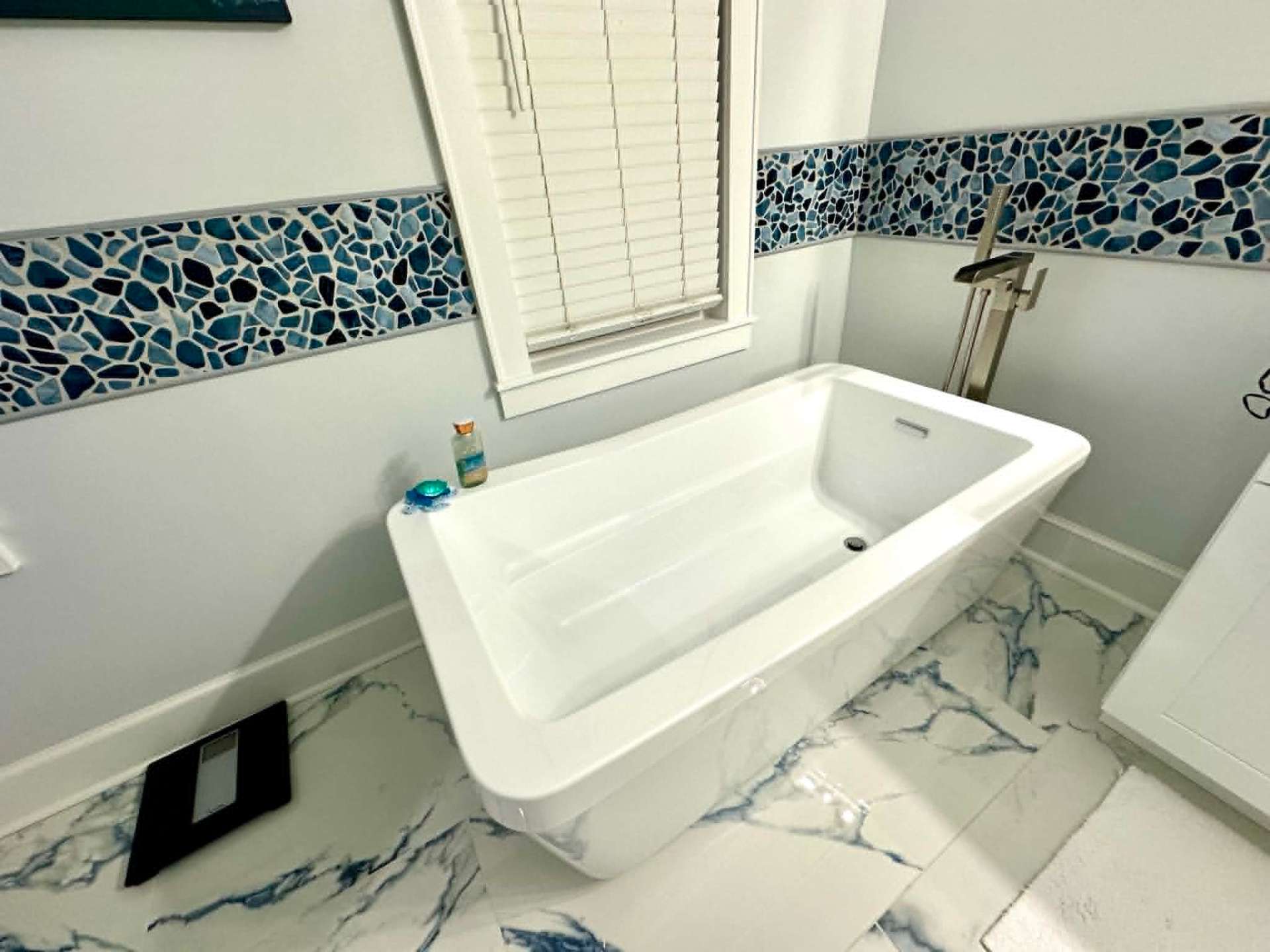 Modern freestanding tub with marble floor, freshly cleaned