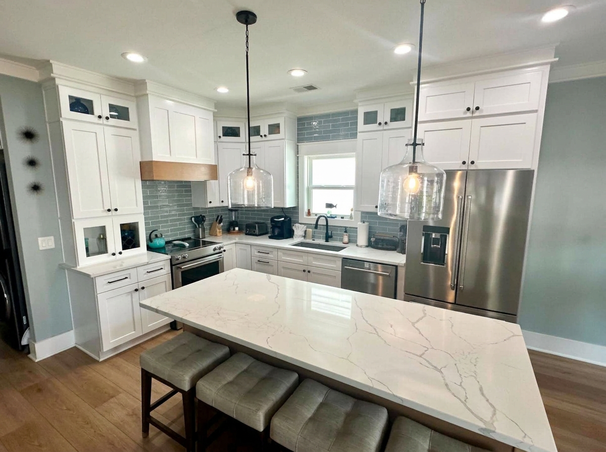 Bright, freshly cleaned coastal kitchen with quartz island